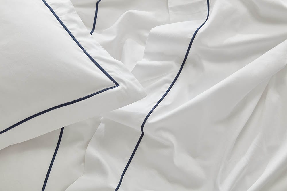 Close-up image of the fitted sheet from our organic cotton bedding collection