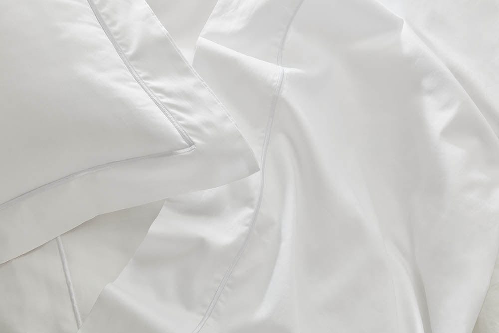 Close-up image of the fitted sheet from our organic cotton bedding collection