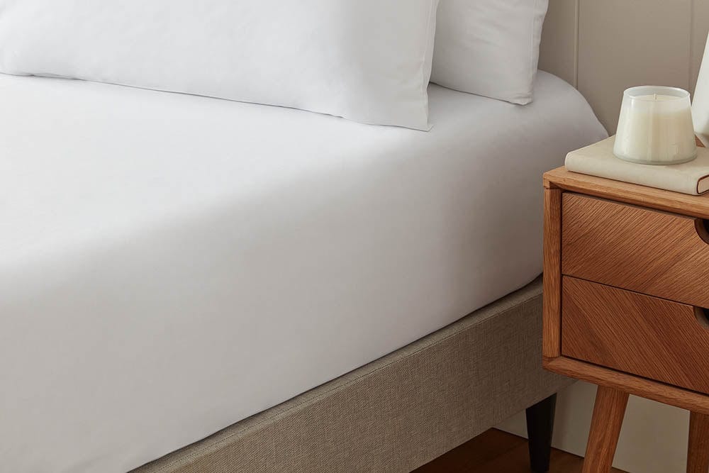 Snug and breathable organic cotton fitted sheet, providing a comfortable foundation for a restful sleep.